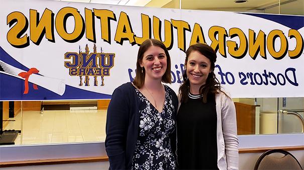 Jen Ruths and Ashley Stumpf pose after graduating with their Au.D.s