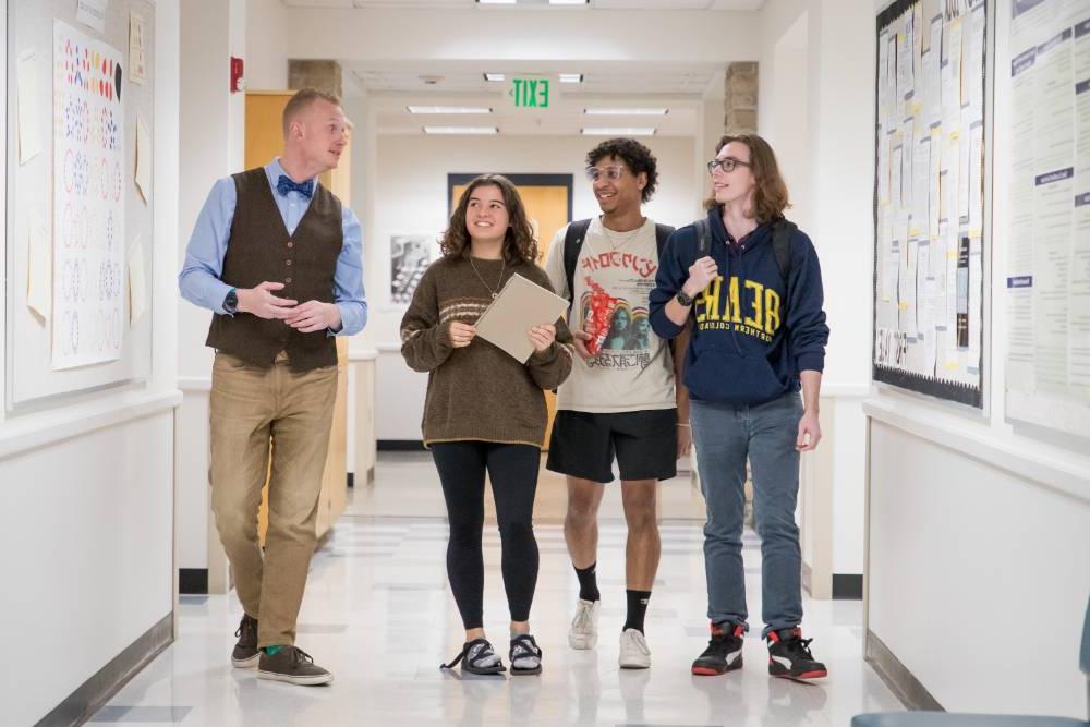 Students walking with professor down math hallway